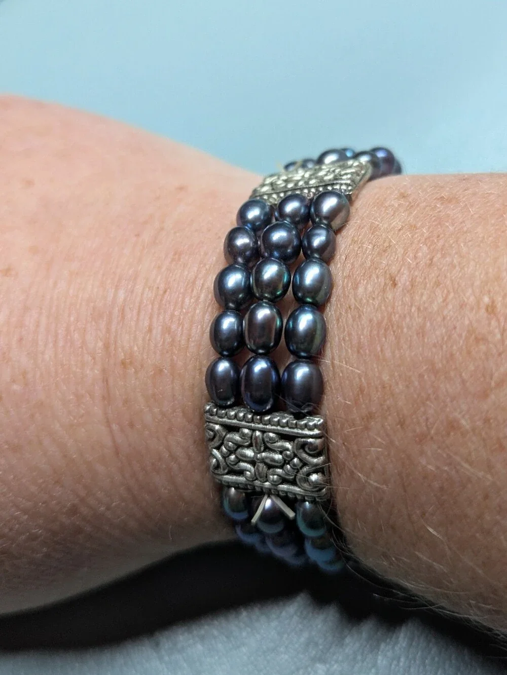 Multi-Strand Black Pearl Bracelet with Ornate Silver Accents
